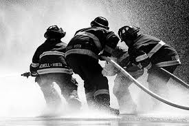 4 Firefighter using a firehose to put out a fire in black and white color